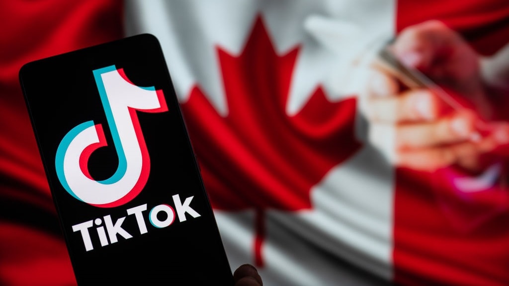 TikTok displayed on mobile with on screen Canada flag, seen in this photo illustration