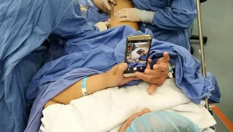Chinese Patient Plays With Her Phone During Operation to Help With Anxiety