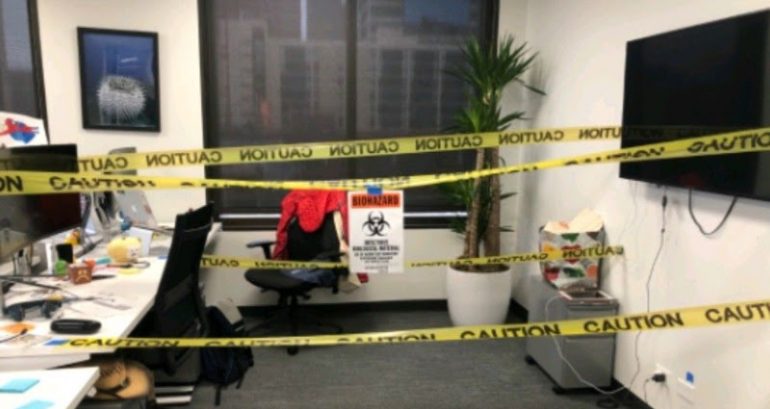 Chinese American employee claims coworkers taped their desk with biohazard sign, caution tape as ‘prank’
