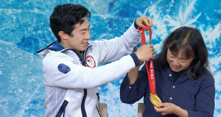 Nathan Chen places his gold medal around his mother’s neck in their first reunion since the Olympics