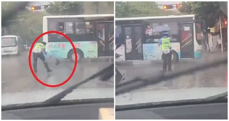 Video: Traffic officer working in the pouring rain gets an opportune gift from a passing bus