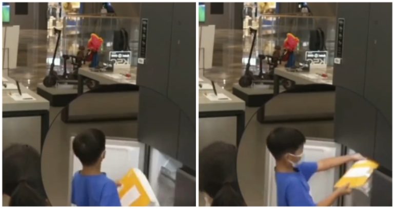 Chinese boy is caught on video trying to hide homework in display refrigerator at store