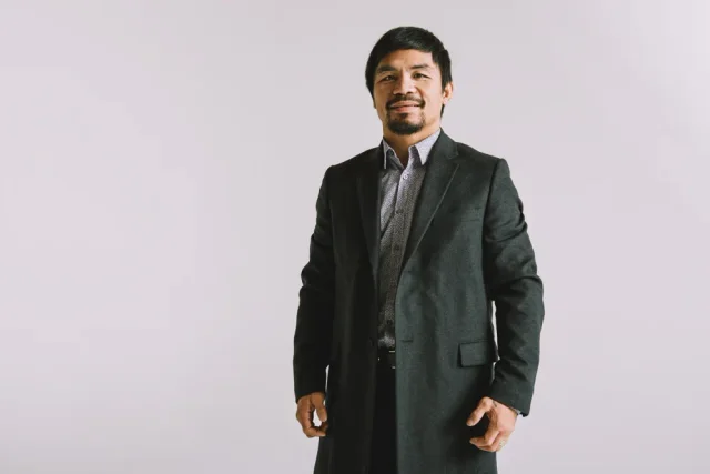 Manny Pacquiao standing in a suit