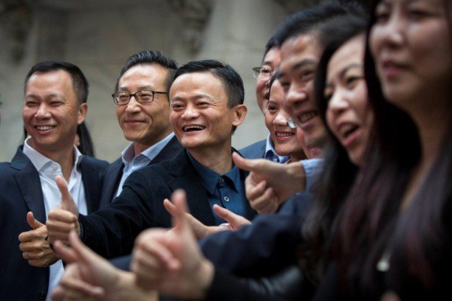 Alibaba Group Holding Ltd founder Jack Ma gestures in front of the New York Stock Exchange before his company's initial public offering (IPO) under the ticker "BABA" in New York